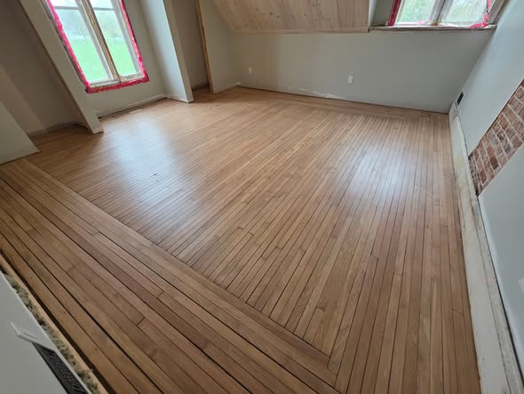 Bedroom hardwood floor refinished to a natural warm finish